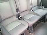 three seats in the back of a van that are empty