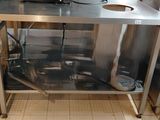 a stainless steel counter with a microwave on top of it