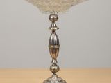 an image of a silver plate on a wooden table with a gray background
