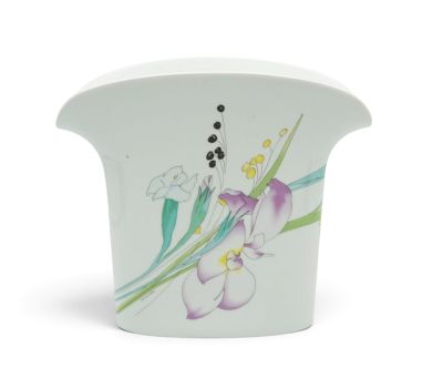 a white vase with a purple flower on it
