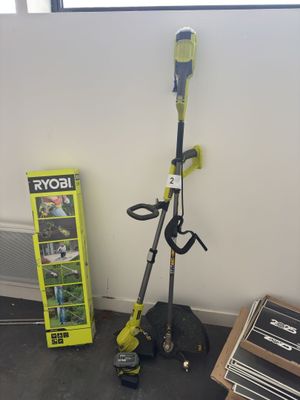 a picture of a green and black lawn mower next to a box of tools