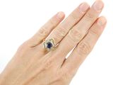 an image of a woman ' s hand with a diamond and sapphire ring