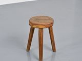 a small wooden stool sitting on the floor in a room