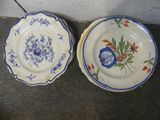 two plates that are sitting next to each other on the floor