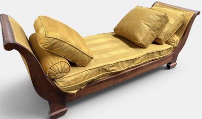 a chaise with pillows on top of it on a white background