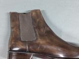 brown leather chelsea boots with a brown rubber sole and a brown rubber sole