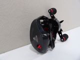 a close up of a fishing reel sitting on a wall