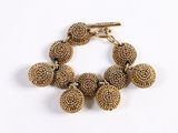an image of a gold bracelet with a bunch of beads on it