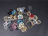 a lot of different colored metal buckles on a table