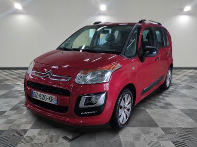 the red citrole is parked on a checkered tile floor