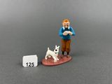 a figurine of a man with a dog next to a calendar