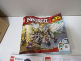 two lego books are sitting on a table next to a box of legos