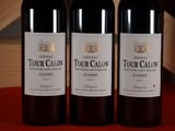 three bottles of wine sitting on top of a table next to each other