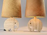 pair of wooden elephant lamps with burlock lampshads on them