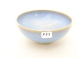a small blue bowl with a white tag on it