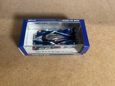 a box with a toy car in it on the floor