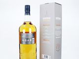an image of a bottle of whisky next to a box on a white surface