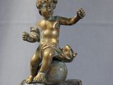 a statue of a child sitting on top of a box