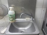 a sink with a bottle of cleaner next to it