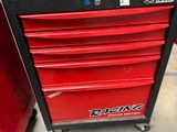 a close up of a red tool cabinet in a garage
