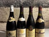 several bottles of wine are lined up on a counter