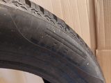 a close up of a tire on a wooden floor next to a cardboard box