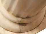 a close up view of a marble pedestal with a vase on it