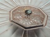 a glass plate with a black stone in it