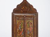 an old wooden cabinet with a painting on the door