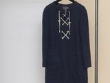 the coat is hanging on a clothes rack in the room