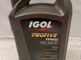 a close up of a bottle of engine oil on a table