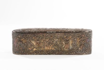 an antique brass box with a floral design on the lid