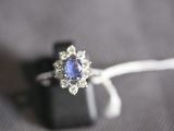 a ring with a blue sapphire and white diamonds on it
