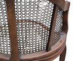 a wooden chair that has a basket on the back of it