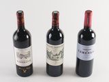 three bottles of wine sitting next to each other on a table