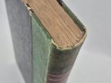 a book that is sitting on a white surface