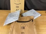 a brown bag with a barcode on it sitting on a table next to a brown bag with a barcode on it