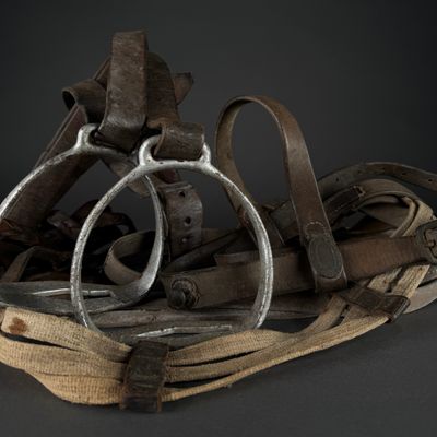 a pile of old leather and metal items on a table