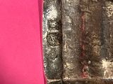 a close up of a metal object on a pink surface