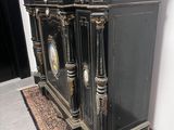 two black cabinets sitting next to each other on a rug