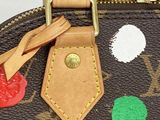 a close up of a purse with a colorful patch on it