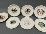 six assiettes à motifs différents posées sur une table