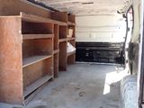 a white van with shelves in the back of it