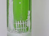 a green glass vase with a picture of a man on a tree