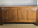 a wooden chest with a wooden top on a tiled floor