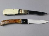 two knives that are sitting next to each other on a table