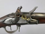 a close up of a gun with a metal handle on a white background