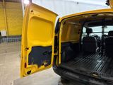 a yellow van with its doors open in a building