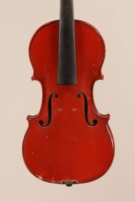 a red violin with a black bow hanging from it ' s back