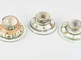 three different types of candlesticks on a white surface